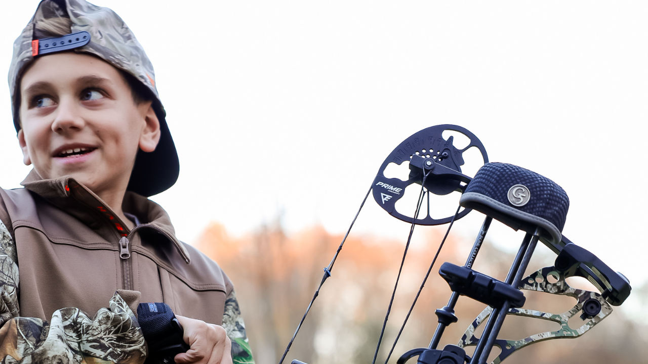 Youth drawing back Prime NXT bow